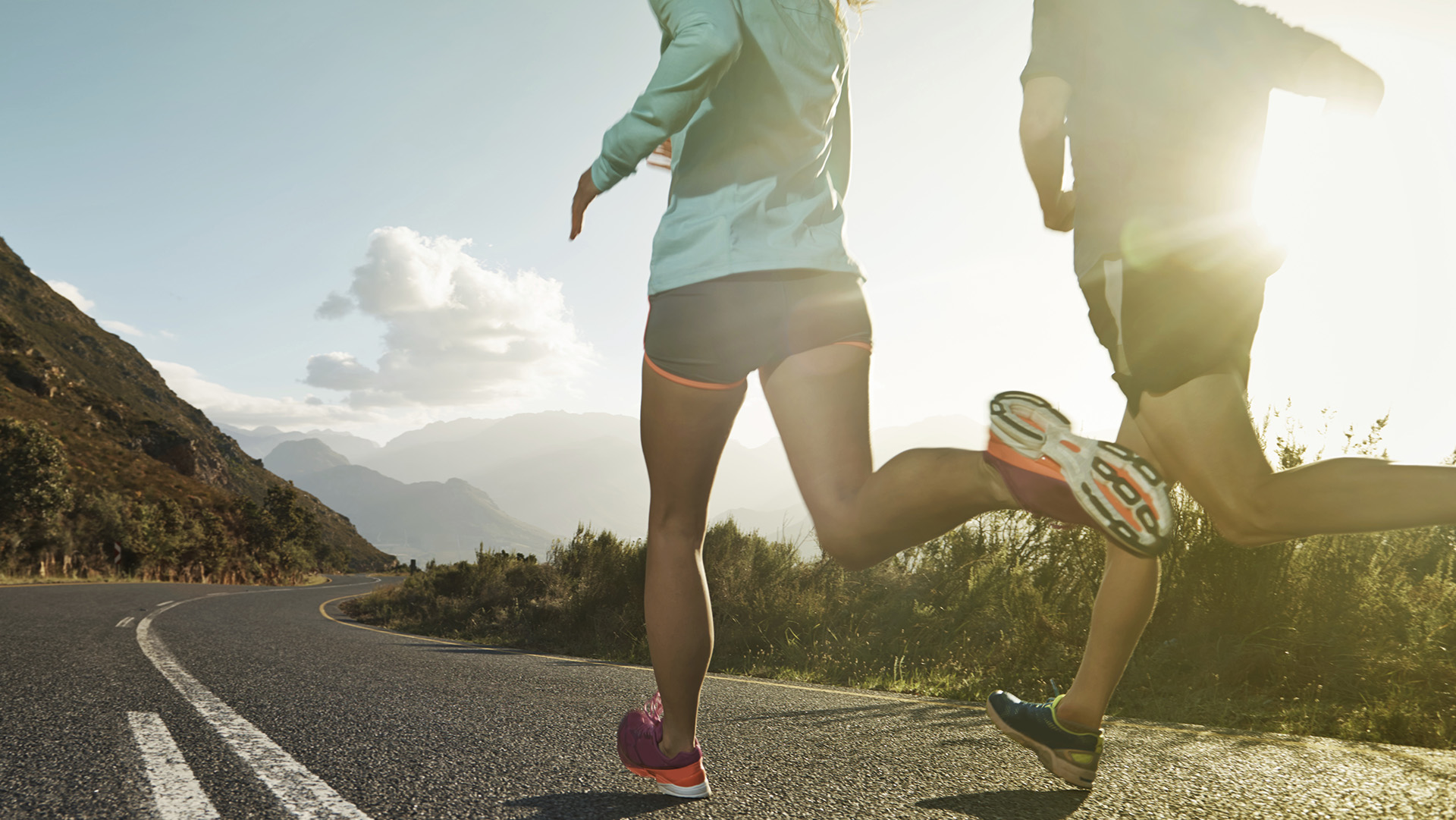 Shot of two people running on a country road