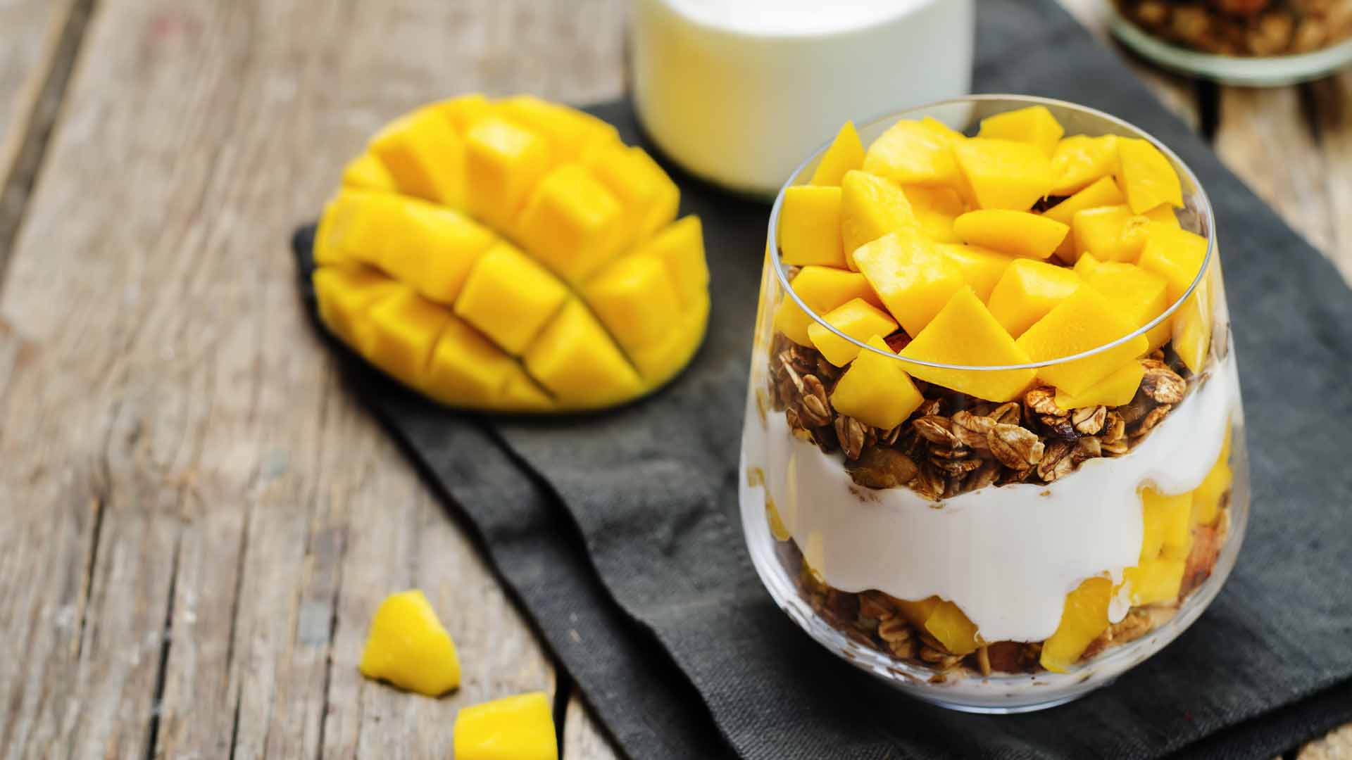 Greek yogurt granola mango parfait. toning. selective focus