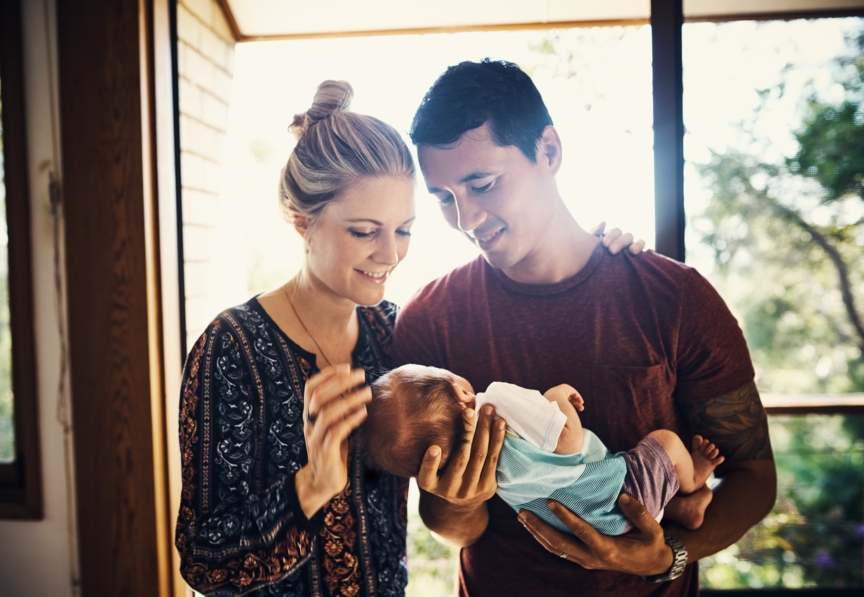 Shot of young parents bonding with their newborn baby boy at home