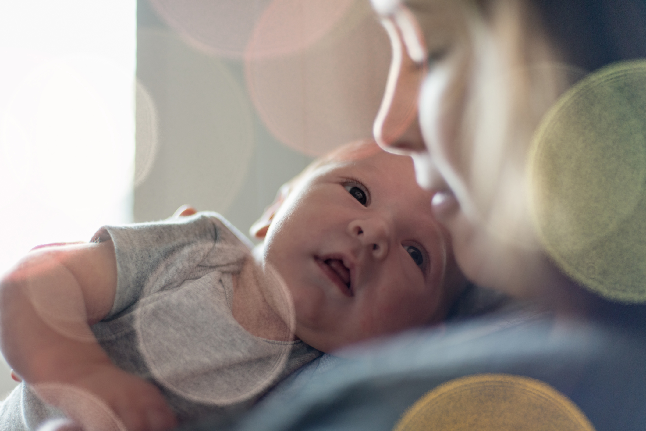 baby boy and mother looking at each other tenderly