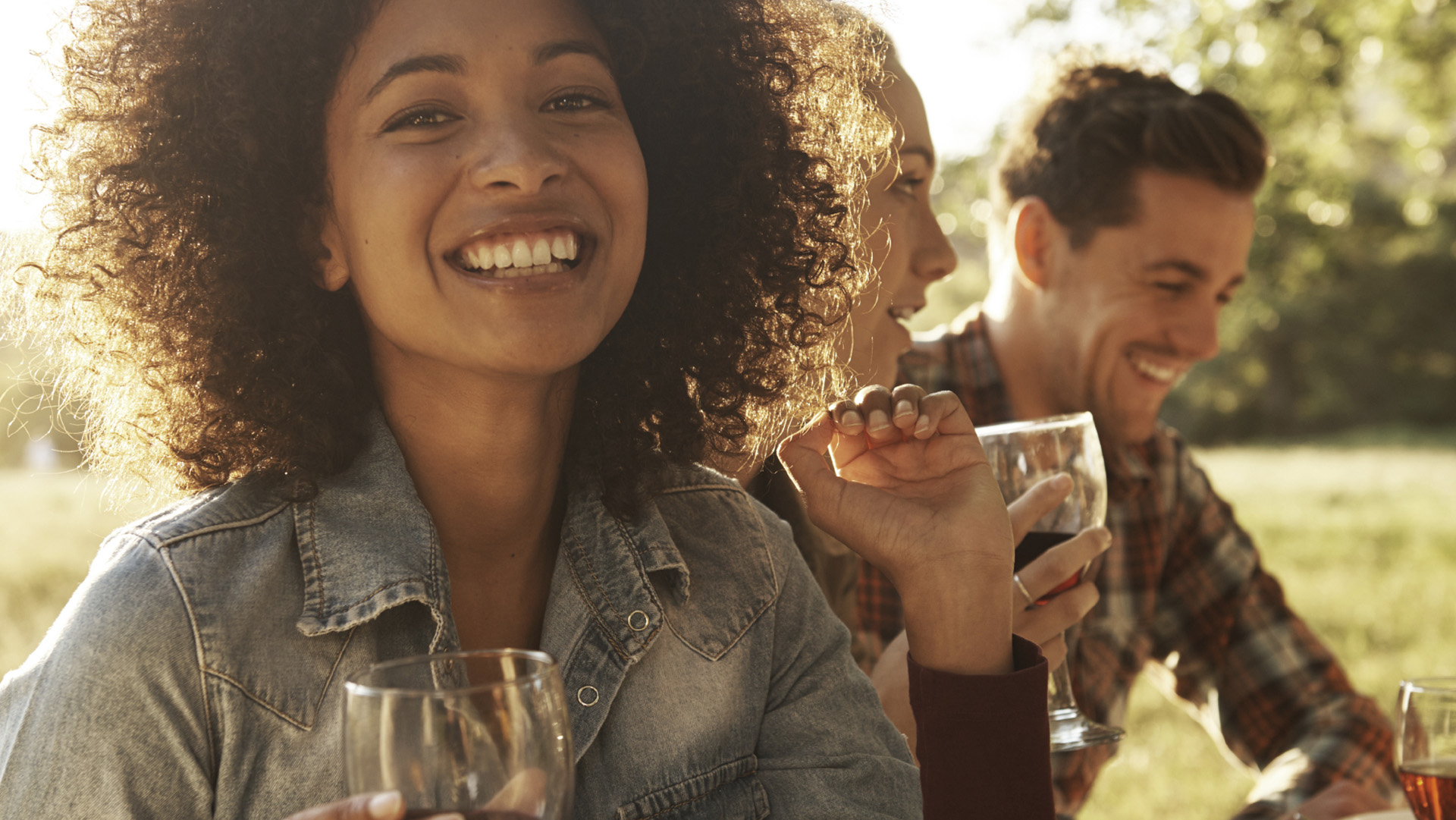 Portrait of a beautiful young woman enjoying an outdoor meal with friends