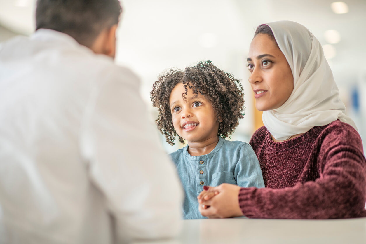 Mother and child speaking with doctor