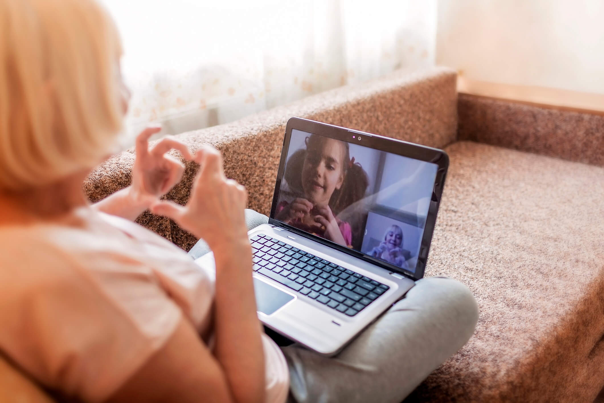 A grandmother talks to her grandchild on Skype.