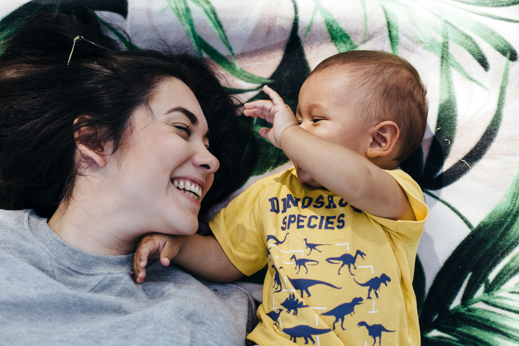 Young mother having nice time at the park with her baby.