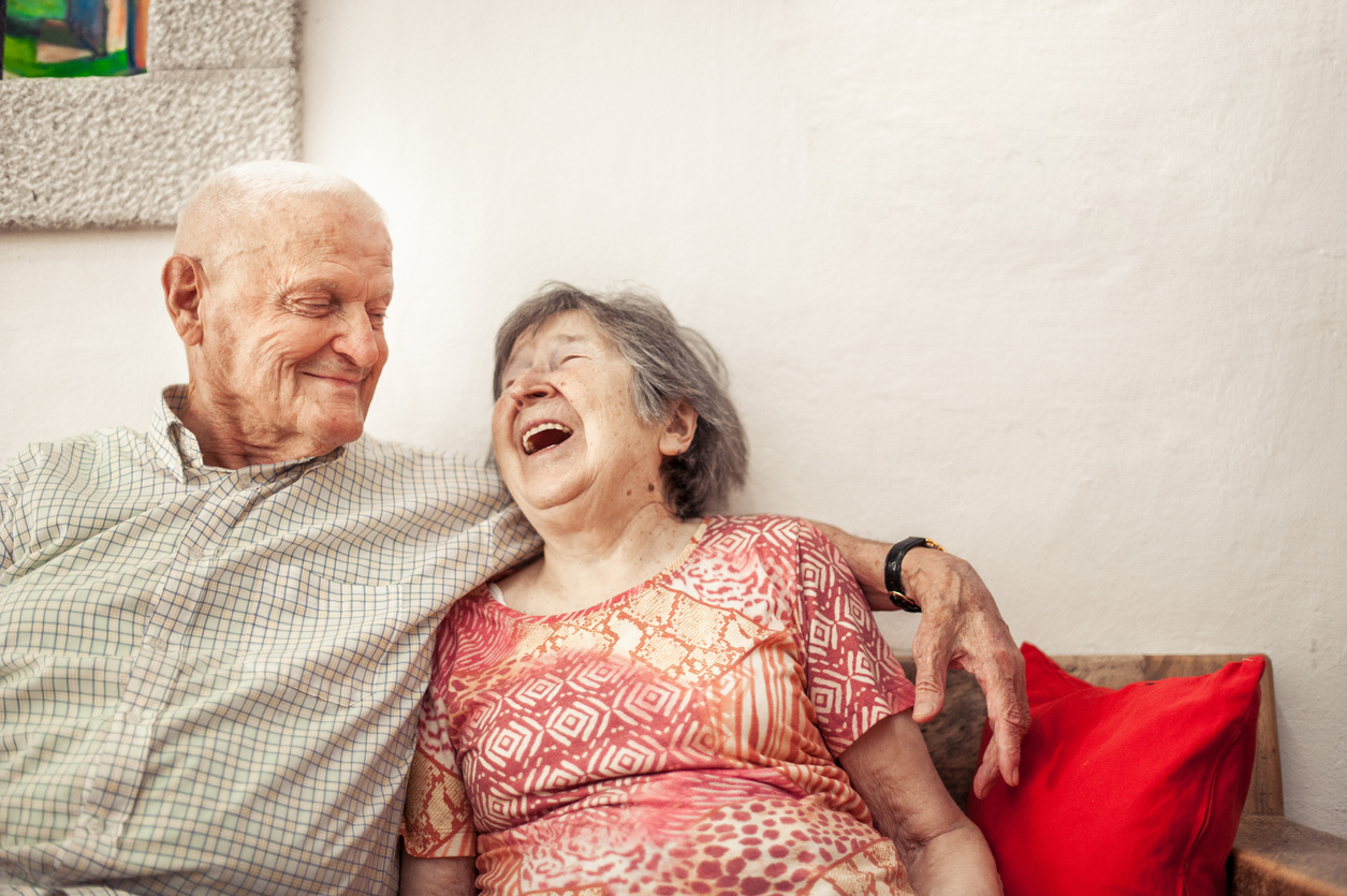 Senior Woman And Senior Man Sitting On The Sofa