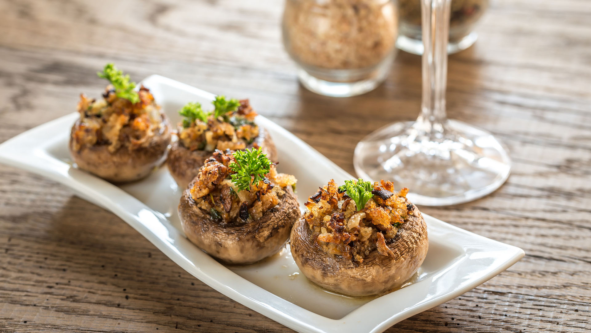 Mushrooms' caps stuffed with mixture of cheese, onion, breadcrumbs and butter