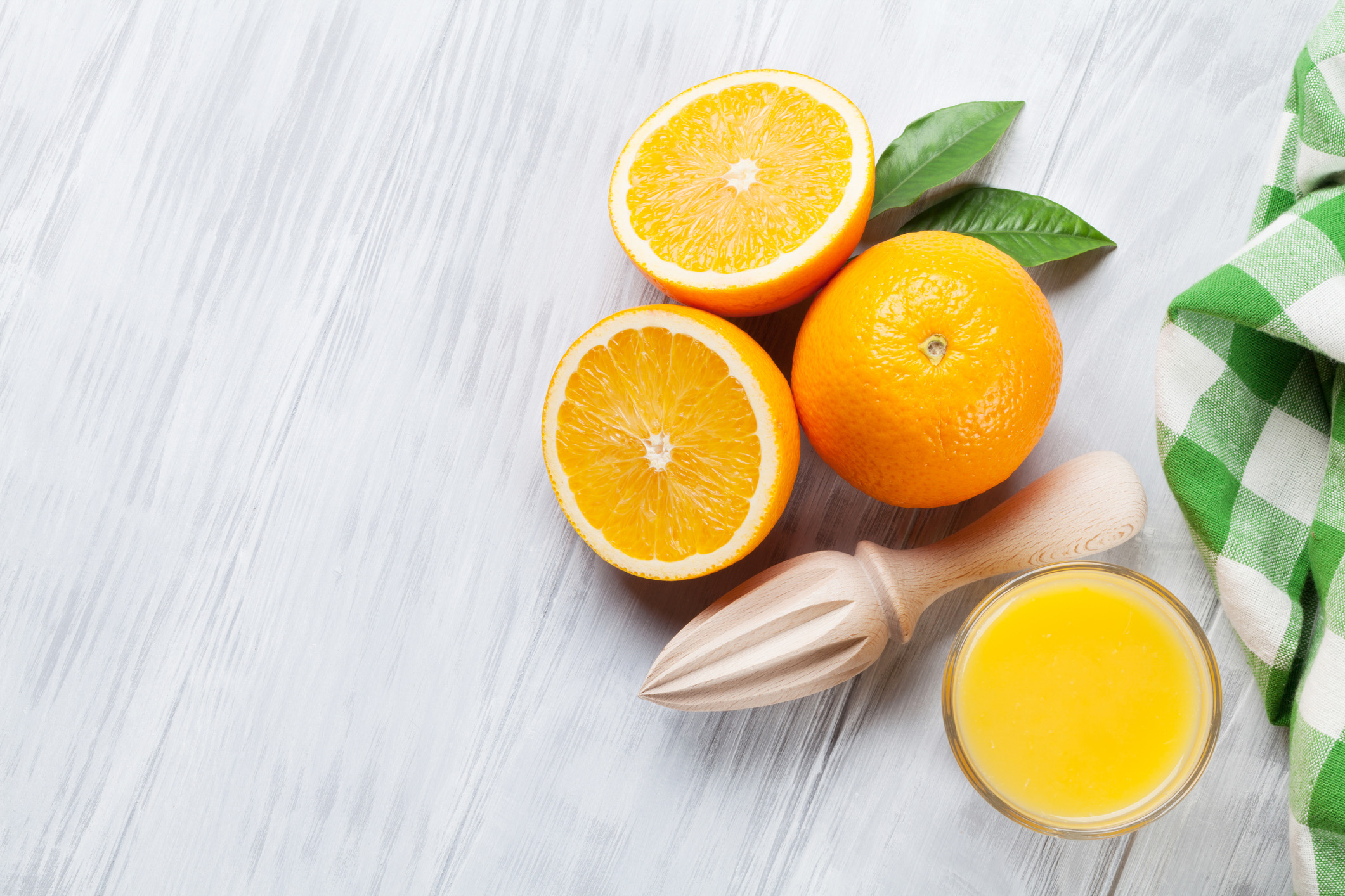 Fresh ripe oranges and juice on wooden table. Top view with copy space