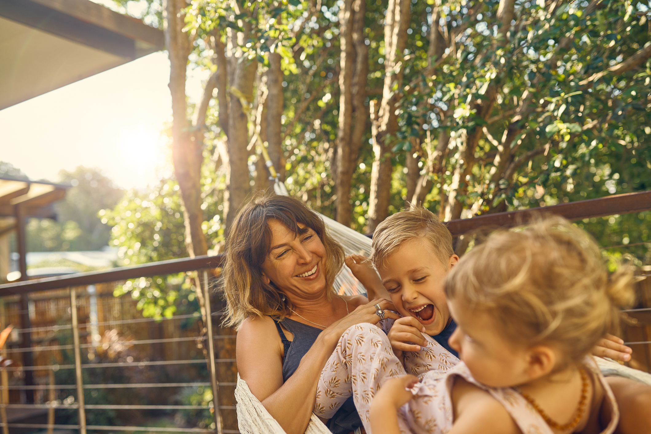 woman in hammock with two kids
