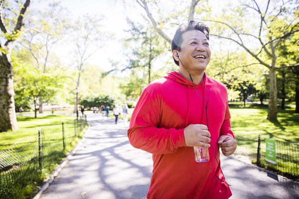 A mature hispanic man working out in central park in New York City