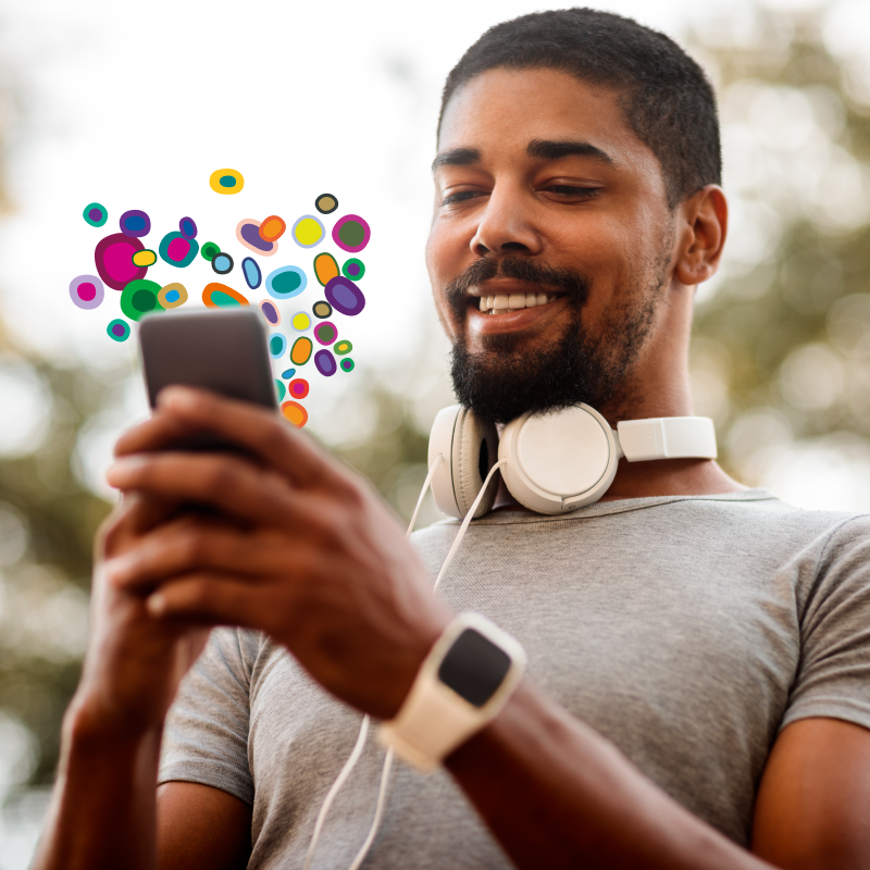 Man smiling at phone that he is holding 