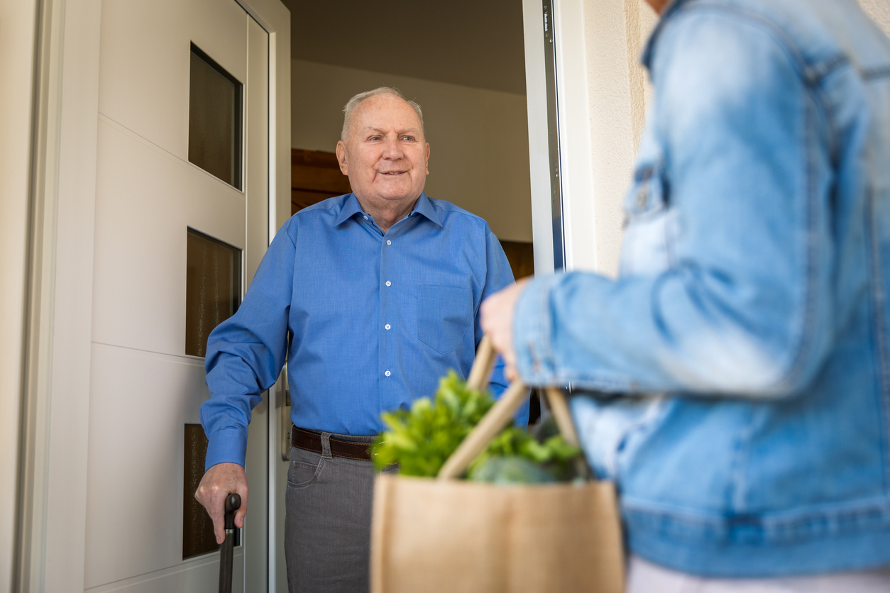 Home caregiver â   woman helping senior man