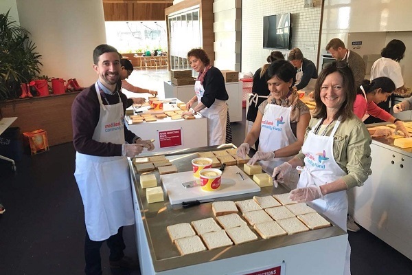 A group of people volunteering making food