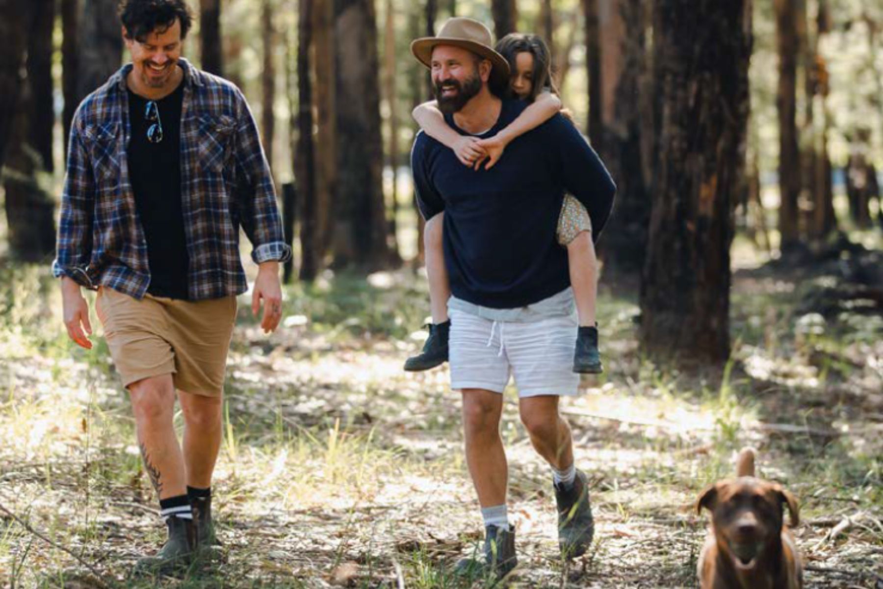 Two men walking through a forest