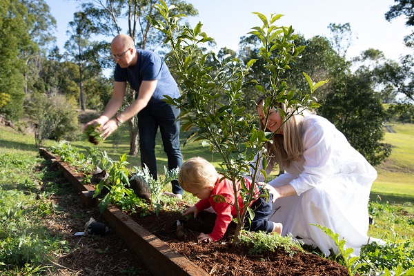 A young family gardening together