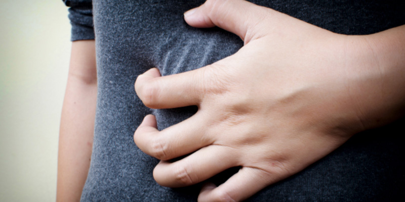 A person holding their stomach A person holding their stomach