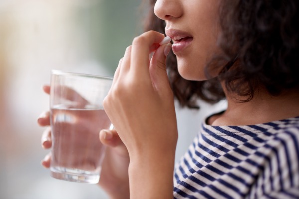 A woman taking her medication