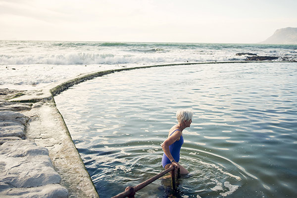 woman walking into the ocean