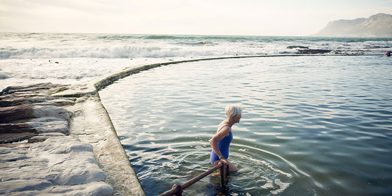 a woman going for a swim in the ocean