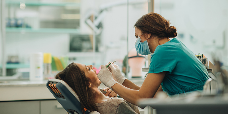 a dentist delivering a dental procedure