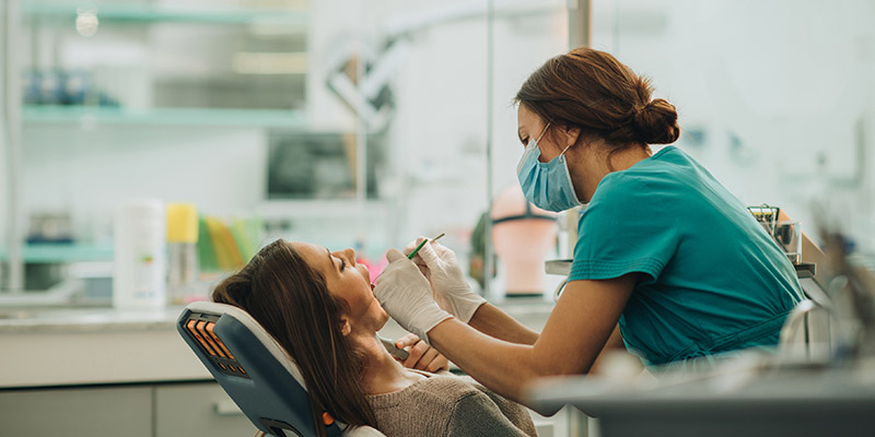 a woman in a dentist chair 
