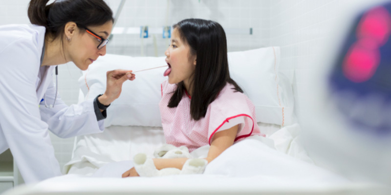 A child getting their tonsils assessed