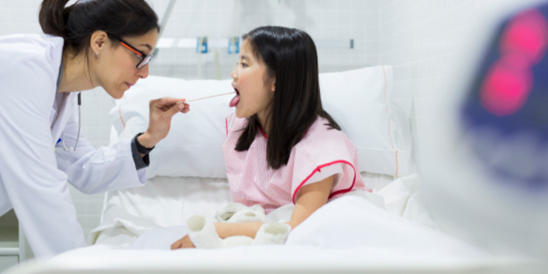 A child getting their tonsils assessed A child getting their tonsils assessed