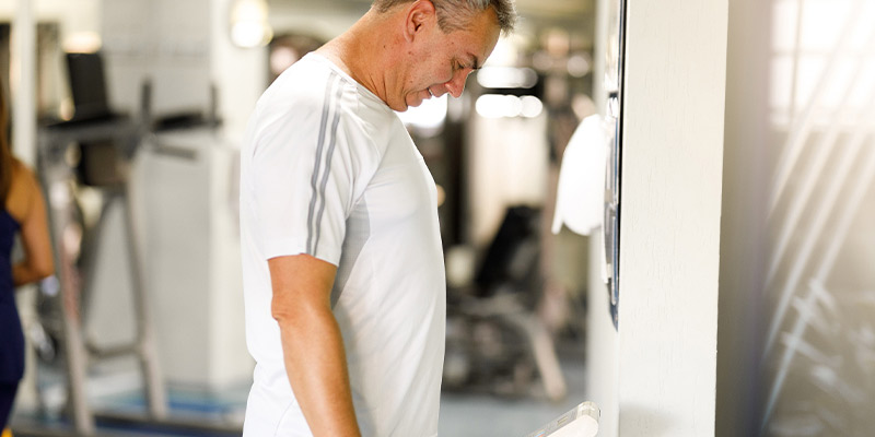 an image of a man weighing himself