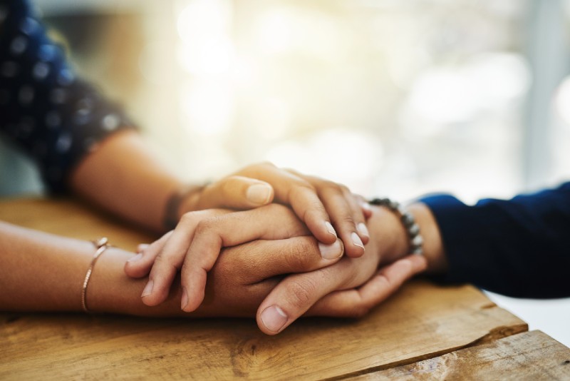 holding hands on a table