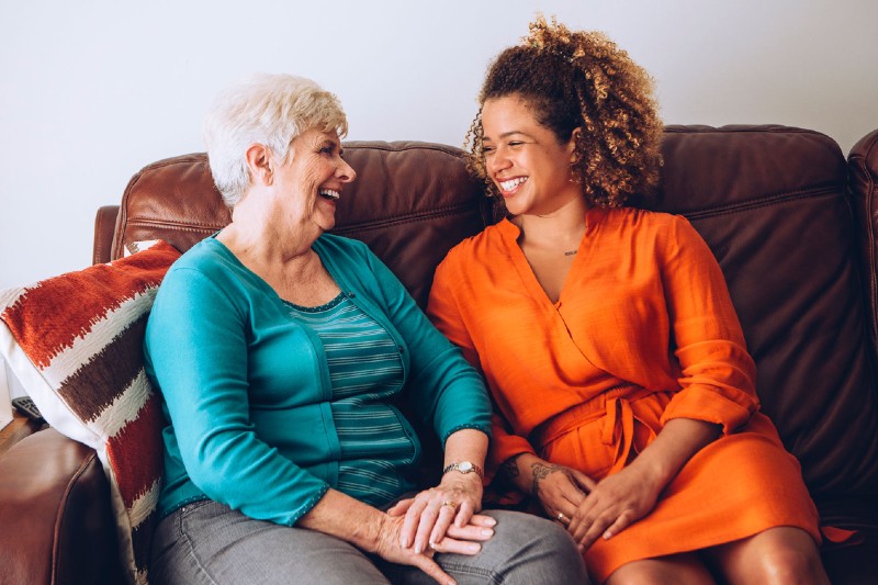 Two woman talking on the couch