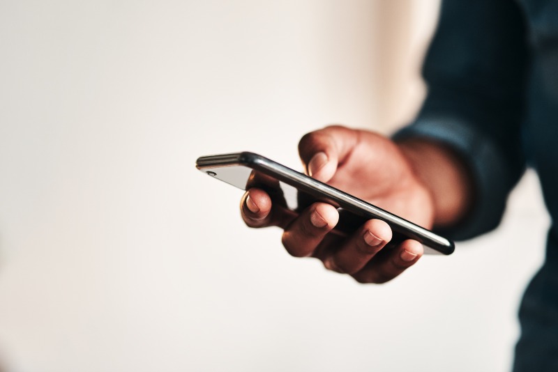 man's hand with a mobile phone