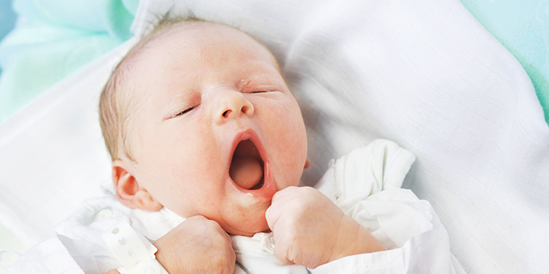 A newborn baby yawning