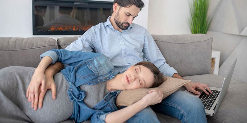 A pregnant woman resting on the couch