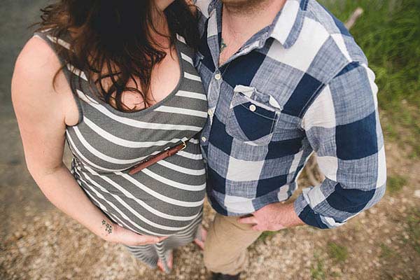 A pregnant woman and her partner A pregnant woman and her partner