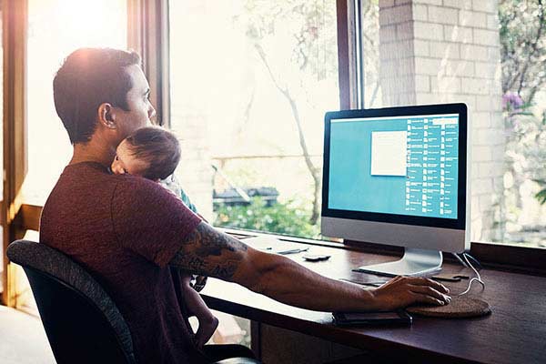 A dad working with his newborn baby