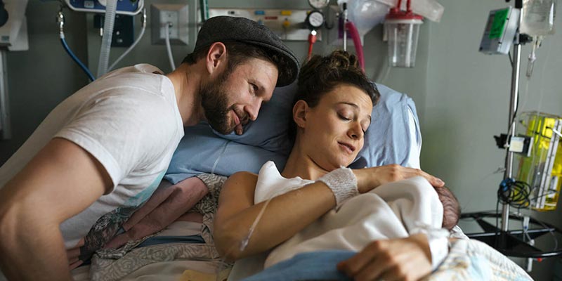 A couple at hospital with their newborn baby