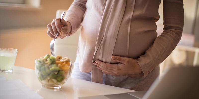 pregnant woman eating healthy food