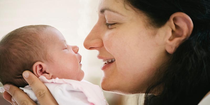 A mother embracing her newborn