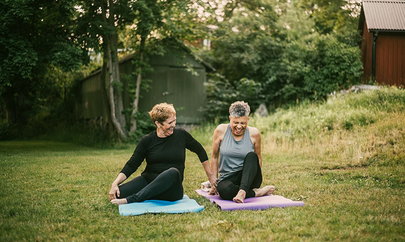 2 women exercising together outdoors