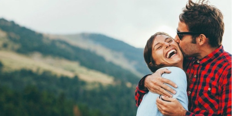 Young adults hugging outdoors