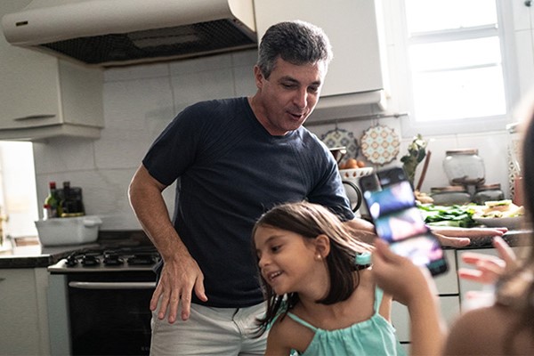 Two people dancing in the kitchen