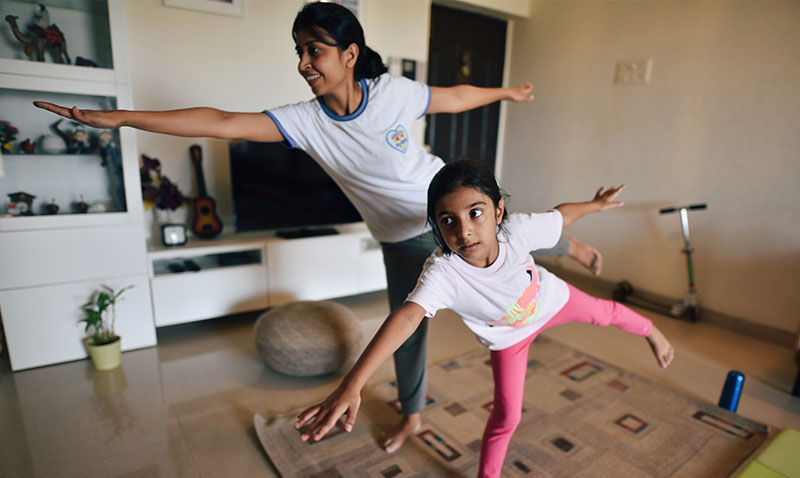 Mother and daughter perform exercises at home