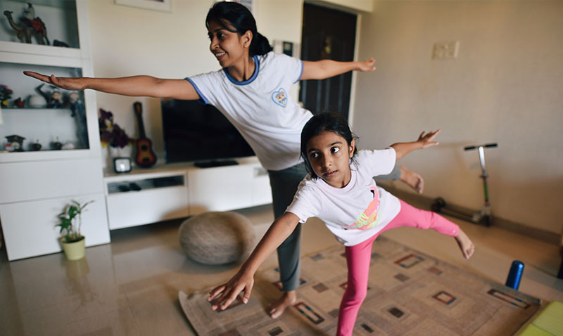 Mother and daughter perform exercises at home Mother and daughter perform exercises at home