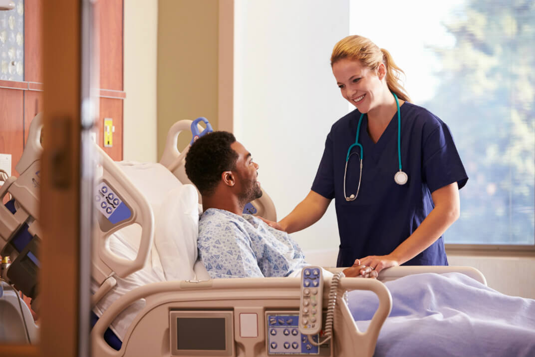 Nurse looking after a male patient in hospital