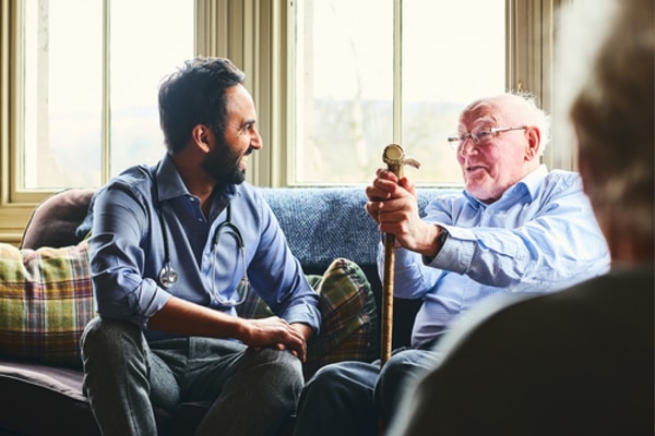 doctor with an elderly patient at home