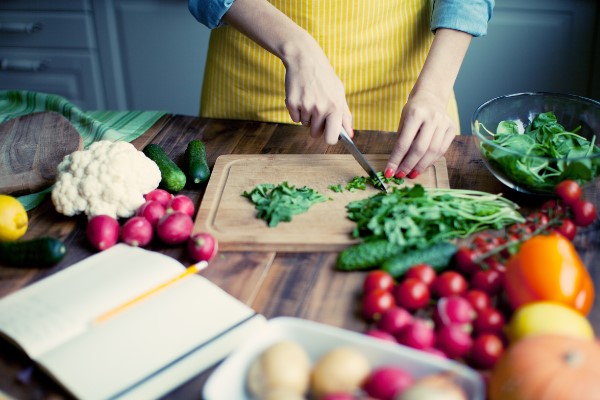 A kitchen bench with fresh fruit and vegetables