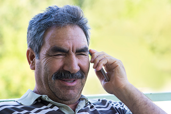 person smiling while using their phone