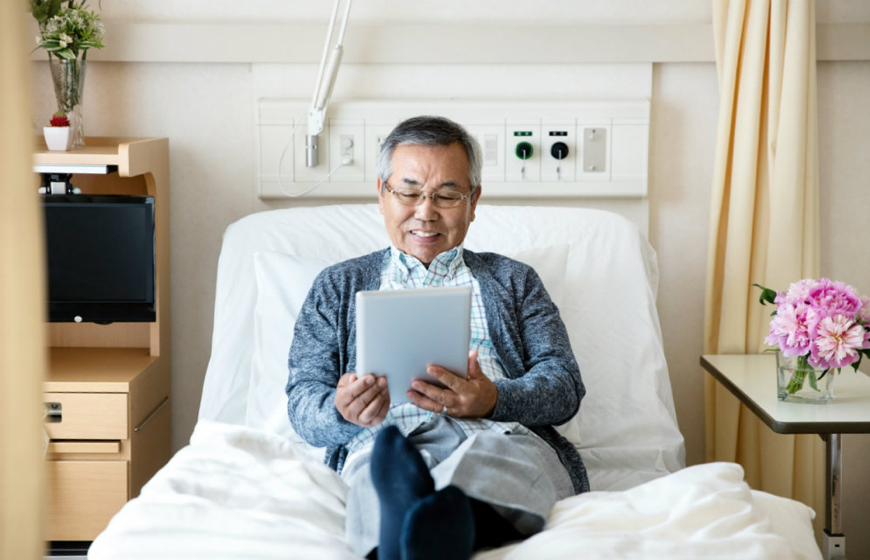 A man resting on his hospital bed