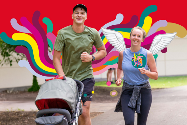 Young parents jogging at parkrun with their baby in a pram