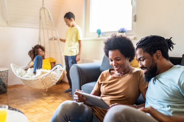 A visiting couple look at an iPad together