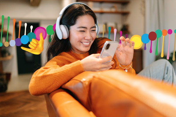 A student looking at their phone, smiling